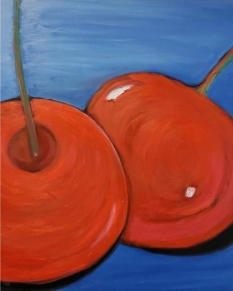 Two glossy red cherries on a deep blue background.